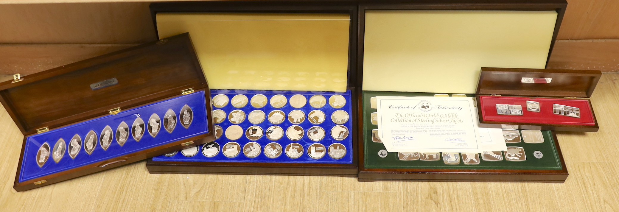 Four assorted modern cased silver ingot sets, to include 'The Beauty of Britain's Churches', 47oz, 'The Official World Wildlife Collection', 49oz, 'The Queens Beasts', 15oz and 'The Royal Standards' 3.5oz